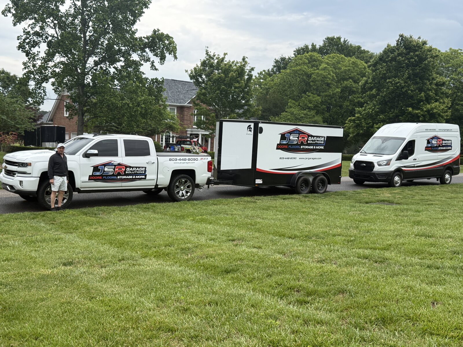 JSR Garage Solutions truck, trailer and van parked at a customer's home
