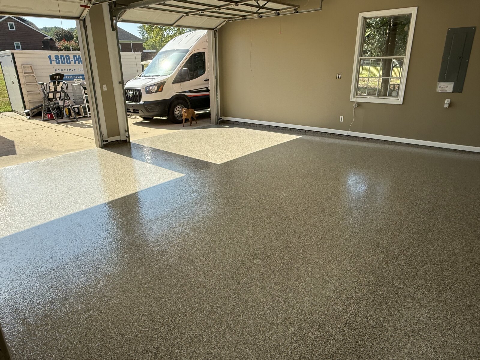 Wide garage with glossy flake floor coating and open door